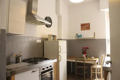 a kitchen with a white refrigerator and a table at Apartment Flaminio in Rome