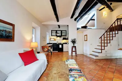 a living room with a white couch and a table at Trastevere Charming Loft | Romeloft in Rome
