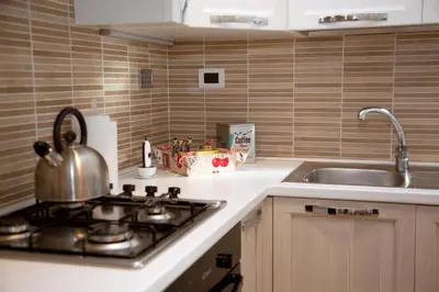a kitchen counter with a stove and a sink at Accogliente Appartamento al Colosseo in Rome