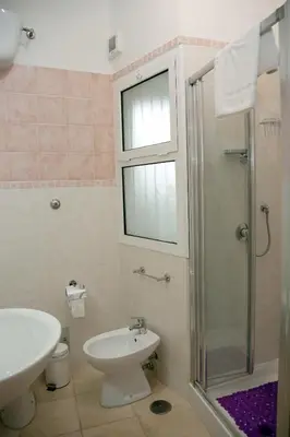 a bathroom with a toilet sink and a shower at Accogliente Appartamento al Colosseo in Rome