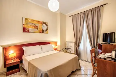 a hotel room with a bed and a tv at Residenza Praetoria in Rome