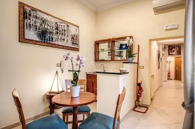 a kitchen and dining room with a table and chairs at Residenza Praetoria in Rome
