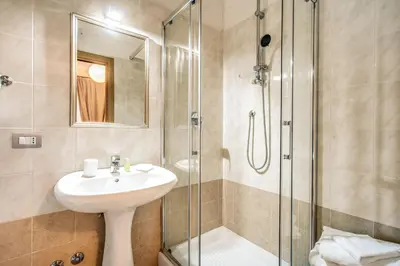 a bathroom with a sink and a shower at Residenza Praetoria in Rome