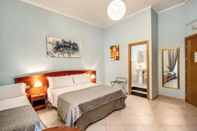 a bedroom with a large bed and a bathroom at Residenza Praetoria in Rome