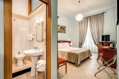 a bathroom with a bed and a sink in a room at Residenza Praetoria in Rome