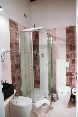 a bathroom with a shower and a toilet and a sink at Navona Nice Room in Rome