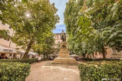 a statue in the middle of a park with trees at Navona Nice Room in Rome