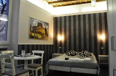 a bedroom with a bed and a table with chairs at Navona Nice Room in Rome