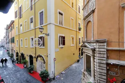 a group of buildings with people walking down a street at Residenza Torre Vecchiarelli - apt 3 in Rome