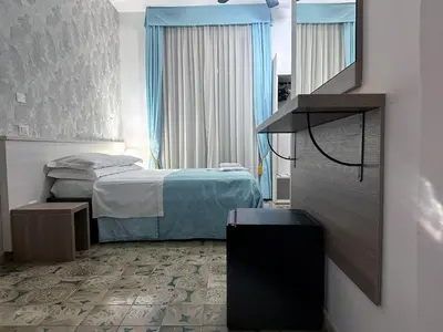 a hotel room with a bed and a mirror at Guesthouse Alex II in Rome