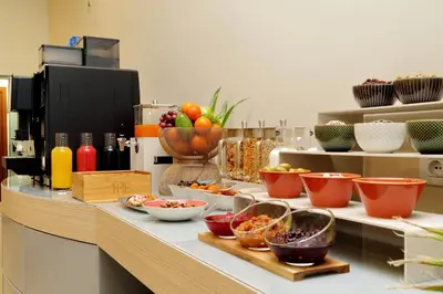 a counter with many bowls of food on it at Casa Santa Sofia in Rome