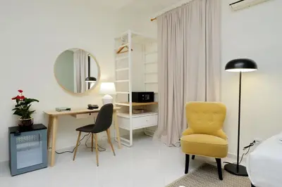a bedroom with a desk and a yellow chair at Casa Santa Sofia in Rome