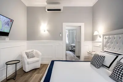 a hotel room with a bed and a tv on the wall at Piazza di Spagna Just for Us in Rome