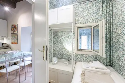 a bathroom with blue and white patterned walls at Pantheon Palazzo Nari in Rome