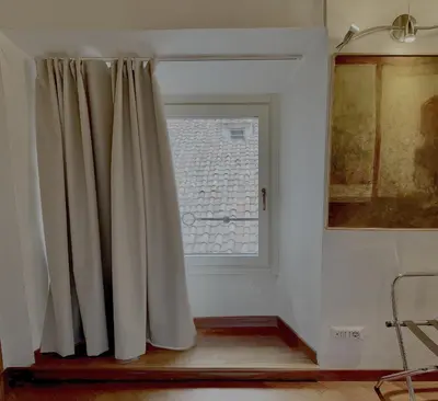 a window with a curtain in a room at Pantheon Palazzo Nari in Rome
