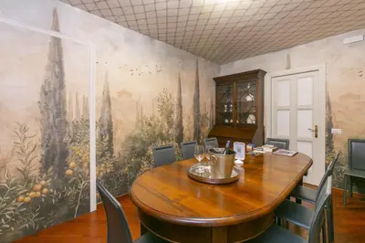 a dining room with a table and a painting on the wall at Pantheon Palazzo Nari in Rome