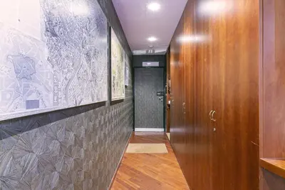 a hallway with a wooden door and a wall at Pantheon Palazzo Nari in Rome