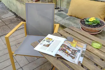 a table with a magazine on top of it at Colosseo Secret Garden - Home and More in Rome