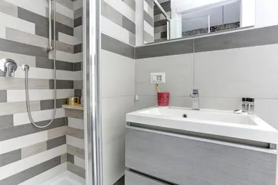 a bathroom with a sink and a shower at Colosseo Secret Garden - Home and More in Rome