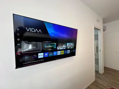 a flat screen tv hanging on a wall at Vatican Modern Apartments KALASA in Rome