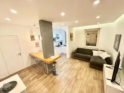 a living room with a couch and a table at Vatican Modern Apartments KALASA in Rome
