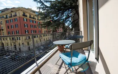 a balcony with a table and two chairs and a window at Vatican Modern Apartments KALASA in Rome