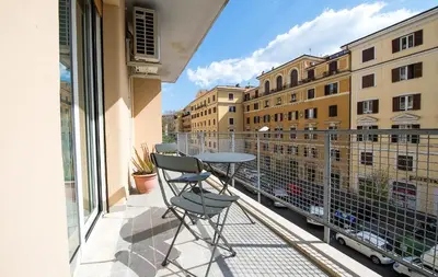 a balcony with a table and chairs on it at Vatican Modern Apartments KALASA in Rome