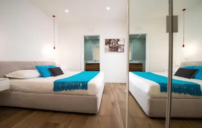 a bedroom with two beds and a couch at Vatican Modern Apartments KALASA in Rome