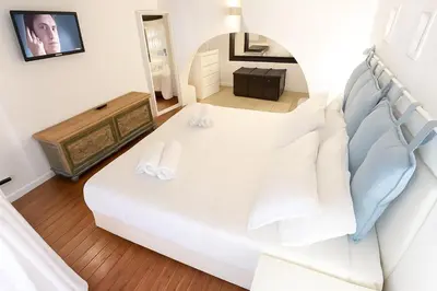a white bed with white pillows in a room at Trastevere Stars in Rome