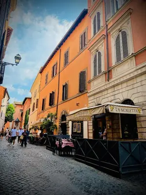 a group of people walking down a street next to a building at Trastevere Stars in Rome