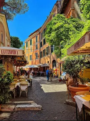 a city street with tables and chairs and buildings at Trastevere Stars in Rome
