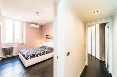 a bedroom with a bed and a window at Balestra Palace Apartment in Rome