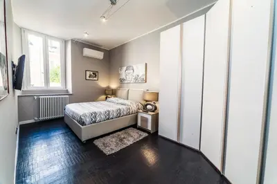 a bedroom with a bed and a window at Balestra Palace Apartment in Rome