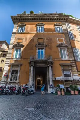 a large building with motorcycles parked in front of it at Balestra Palace Apartment in Rome