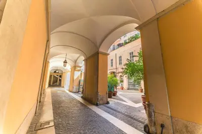 an alley with arches in an old building at Balestra Palace Apartment in Rome