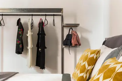 a room with coats and purses hanging on a wall at Maison Letizia Roma in Rome