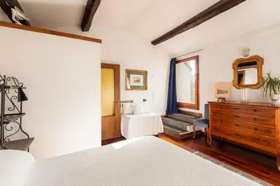 a bedroom with two beds and a dresser and a mirror at Piazza Mattei Terrace Apartment | Romeloft in Rome
