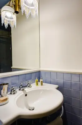 a bathroom with a white sink and a mirror at Casa Heberart Guest House Capo le Case in Rome