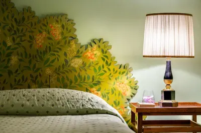 a bedroom with a bed and a table with a lamp at Casa Heberart Guest House Capo le Case in Rome