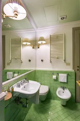 a green bathroom with two sinks and a toilet at Casa Heberart Guest House Capo le Case in Rome