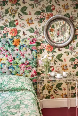 a bedroom with floral wallpaper and a mirror at Casa Heberart Guest House Sistina in Rome