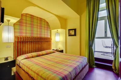 a hotel room with a bed and a window at Casa Heberart Guest House Sistina in Rome