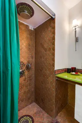 a bathroom with a shower with a green shower curtain at Casa Heberart Guest House Sistina in Rome