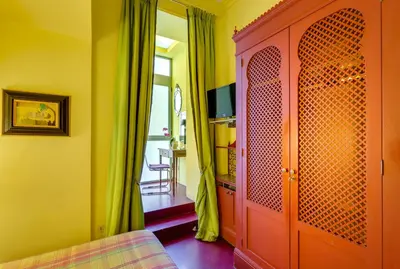 a living room with a red cabinet and a window at Casa Heberart Guest House Sistina in Rome