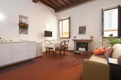a living room with a couch and a table at The Piccolo Apartment in Rome