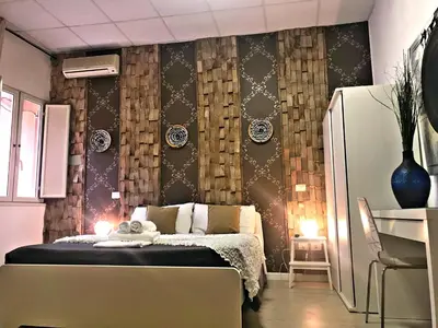 a bedroom with a bed and a table in a room at Magic Door Rome in Rome