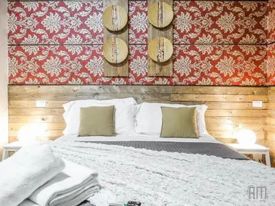 a bedroom with a bed and a red wall at Magic Door Rome in Rome