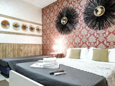 a bedroom with a bed and two mirrors on the wall at Magic Door Rome in Rome