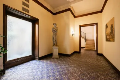 a statue of a woman in a hallway with a window at Il Palazzetto di Via della Frezza in Rome