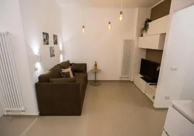 a living room with a couch and a television at Casa Malupa Luxury Apartments in Rome